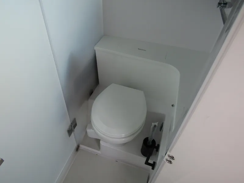 Slide: The Image of 2024 Axopar 37XC CROSS CABIN bathroom with modern white toilet. - 23