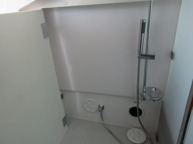 Slide: The Image of 2024 Axopar 37XC CROSS CABIN interior shower area with modern fixtures. - 26