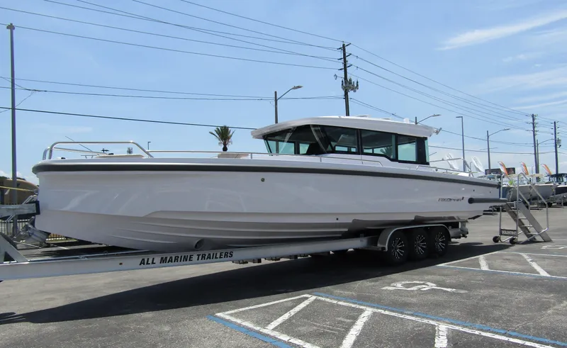 Slide: The Image of 2024 Axopar 37XC CROSS CABIN boat on a trailer in a parking lot. - 4
