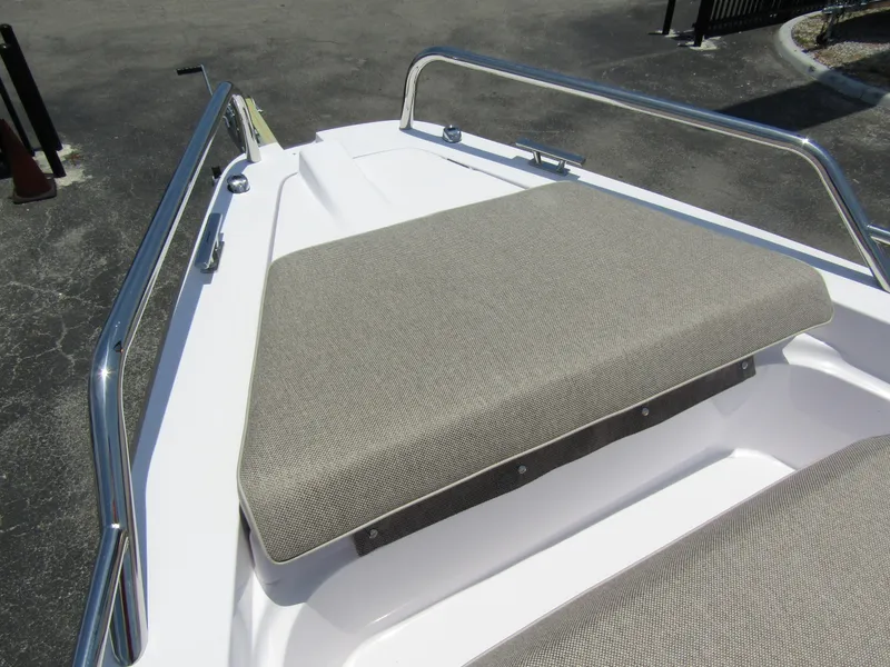 Slide: The Image of 2024 Axopar 37XC CROSS CABIN bow seating area with stainless steel railings. - 7