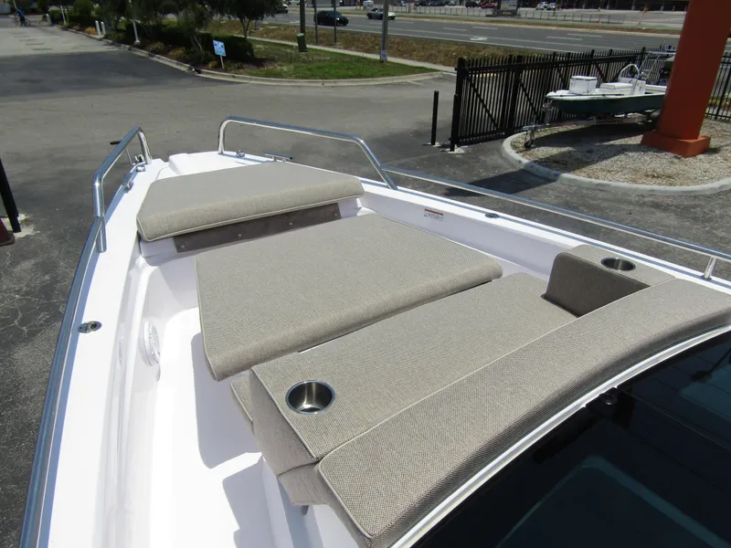 Slide: The Image of 2024 Axopar 37XC CROSS CABIN boat with cushioned sunbathing area and stainless steel cup holders. - 8