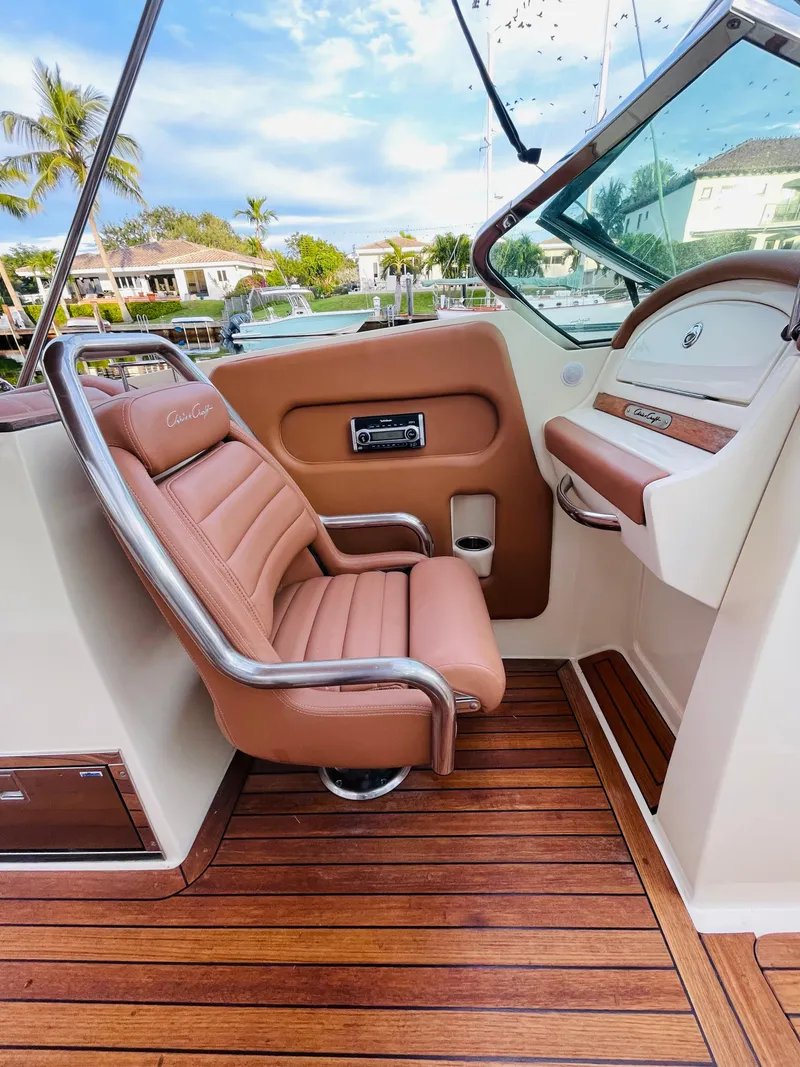Slide: The Image of 2014 Chris-Craft Launch 32 cockpit with tan leather seat and wooden flooring. - 1