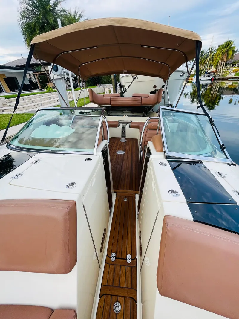 Slide: The Image of 2014 Chris-Craft Launch 32 boat with tan upholstery and wooden deck. - 12