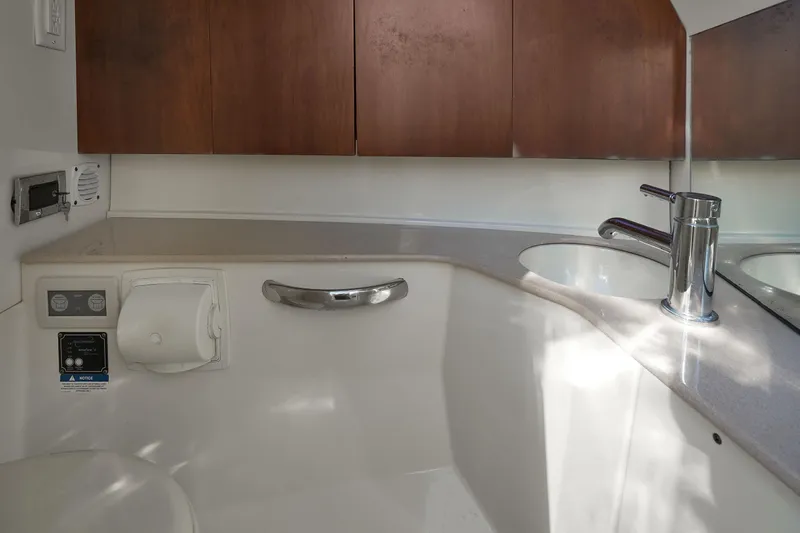 Slide: The Image of 2014 Chris-Craft Launch 32 bathroom with modern sink and wooden cabinets. - 16