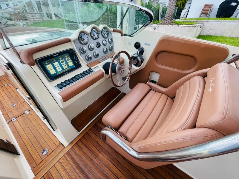 Slide: The Image of 2014 Chris-Craft Launch 32 cockpit with leather seats and modern dashboard. - 2