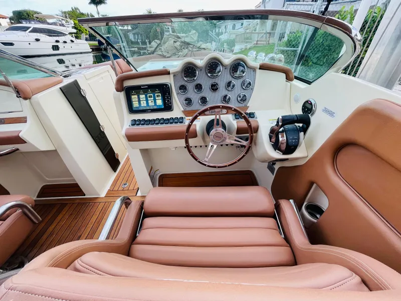 Slide: The Image of 2014 Chris-Craft Launch 32 boat cockpit with leather seats and modern dashboard. - 4
