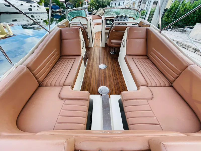 Slide: The Image of 2014 Chris-Craft Launch 32 boat interior with tan leather seating and wooden flooring. - 5