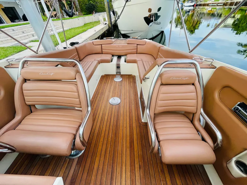 Slide: The Image of 2014 Chris-Craft Launch 32 boat interior with tan leather seats and wooden flooring. - 7