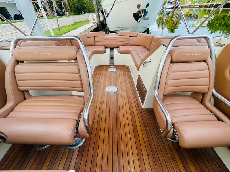 Slide: The Image of 2014 Chris-Craft Launch 32 boat interior with tan leather seats and wooden flooring. - 8