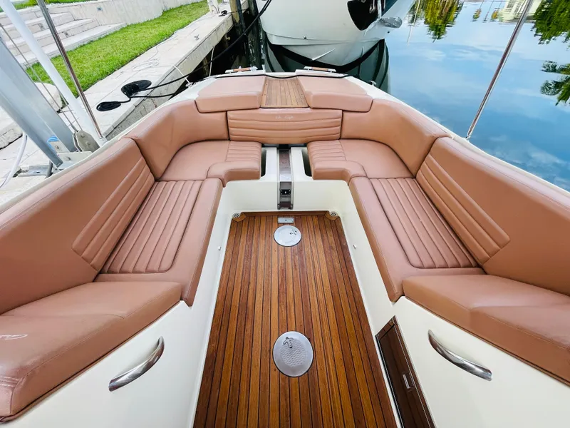 Slide: The Image of 2014 Chris-Craft Launch 32 boat with luxurious tan seating and wooden deck. - 9