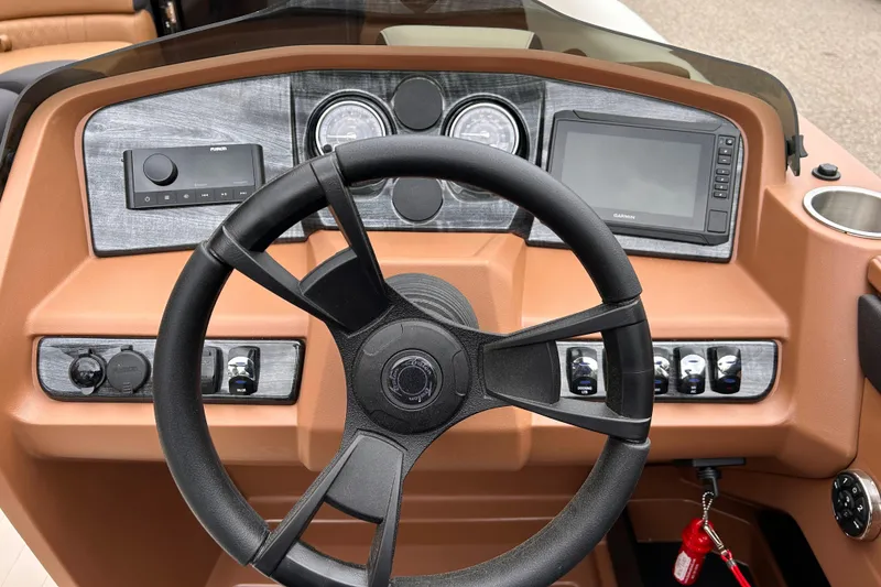 Slide: The Image of 2024 Avalon LSZ Entertainer 23' boat dashboard with steering wheel and control panel. - 11