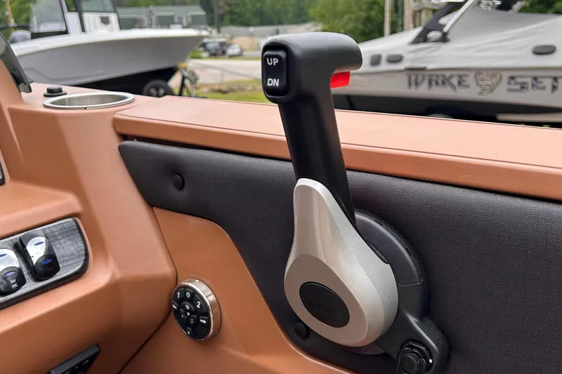 Slide: The Image of 2024 Avalon LSZ Entertainer 23' boat control lever and dashboard. - 13