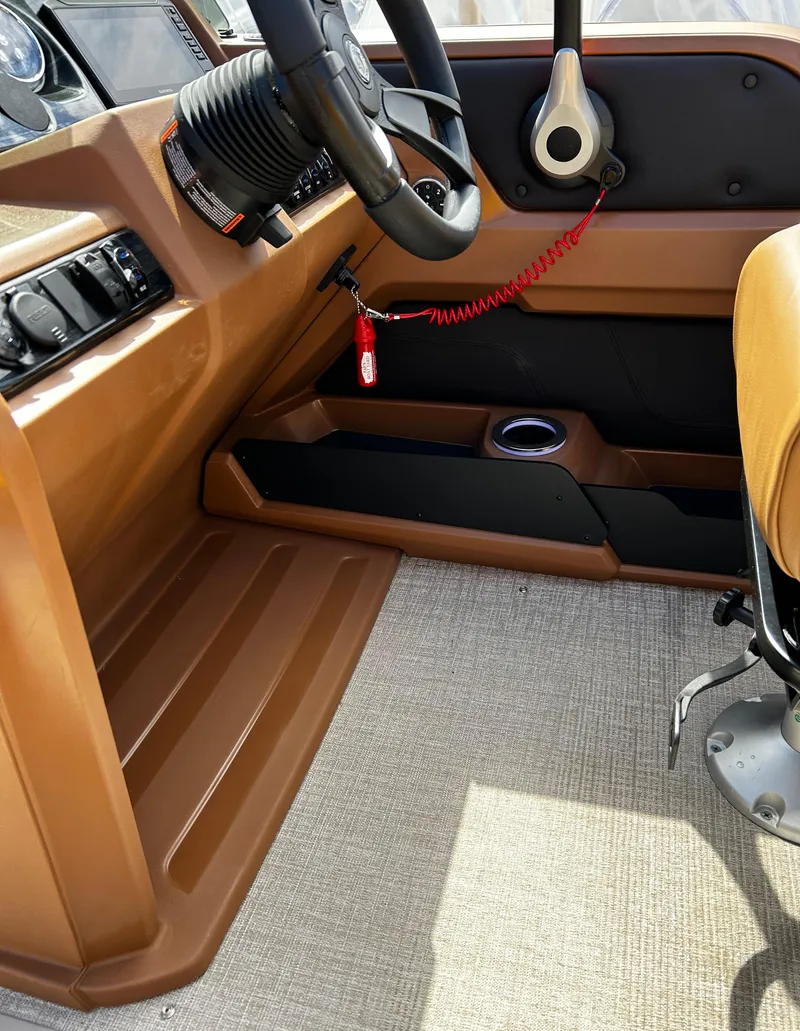Slide: The Image of 2024 Avalon LSZ Entertainer 23' boat interior, steering wheel, and control panel. - 14