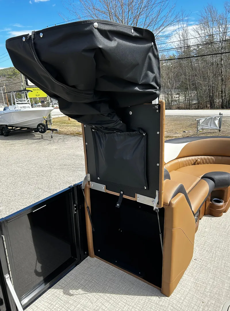 Slide: The Image of 2024 Avalon LSZ Entertainer 23' boat interior with storage compartment open. - 19