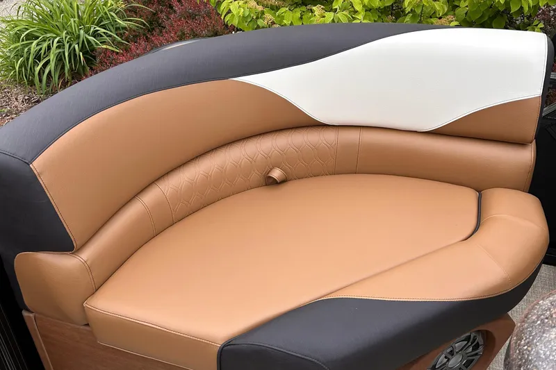 Slide: The Image of 2024 Avalon LSZ Entertainer 23' boat seating with tan, black, and white upholstery. - 22
