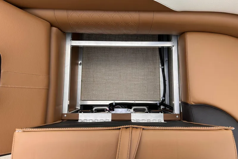 Slide: The Image of 2024 Avalon LSZ Entertainer 23' under-seat storage compartment with brown leather upholstery. - 27