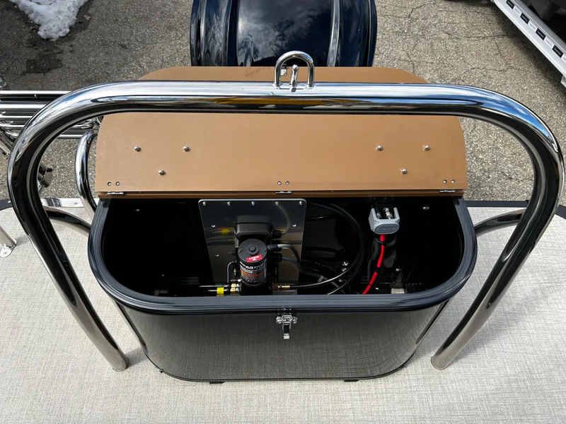 Slide: The Image of 2024 Avalon LSZ Entertainer 23' boat storage compartment with open lid. - 31