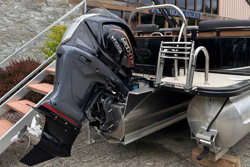 Slide: The Image of 2024 Avalon LSZ Entertainer 23' pontoon boat with a powerful outboard motor. - 35