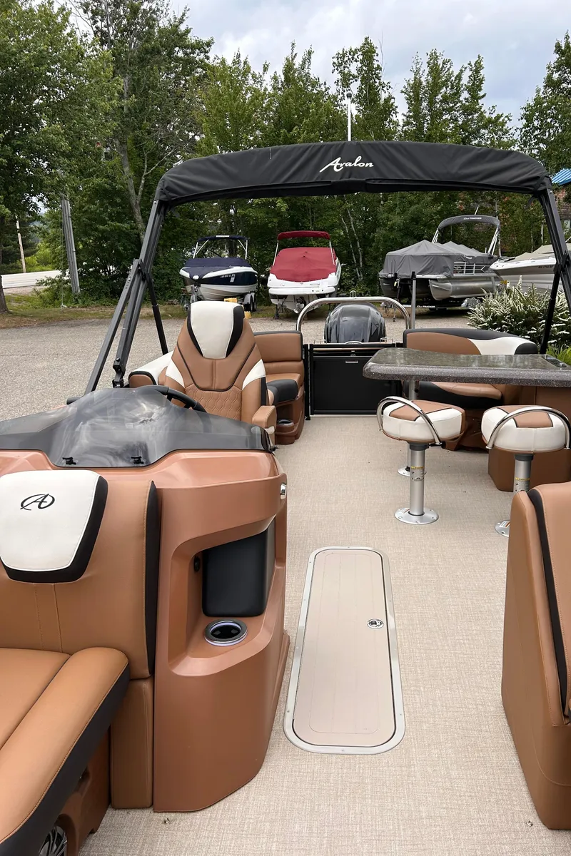 Slide: The Image of 2024 Avalon LSZ Entertainer 23' pontoon boat with luxurious seating and modern amenities. - 6