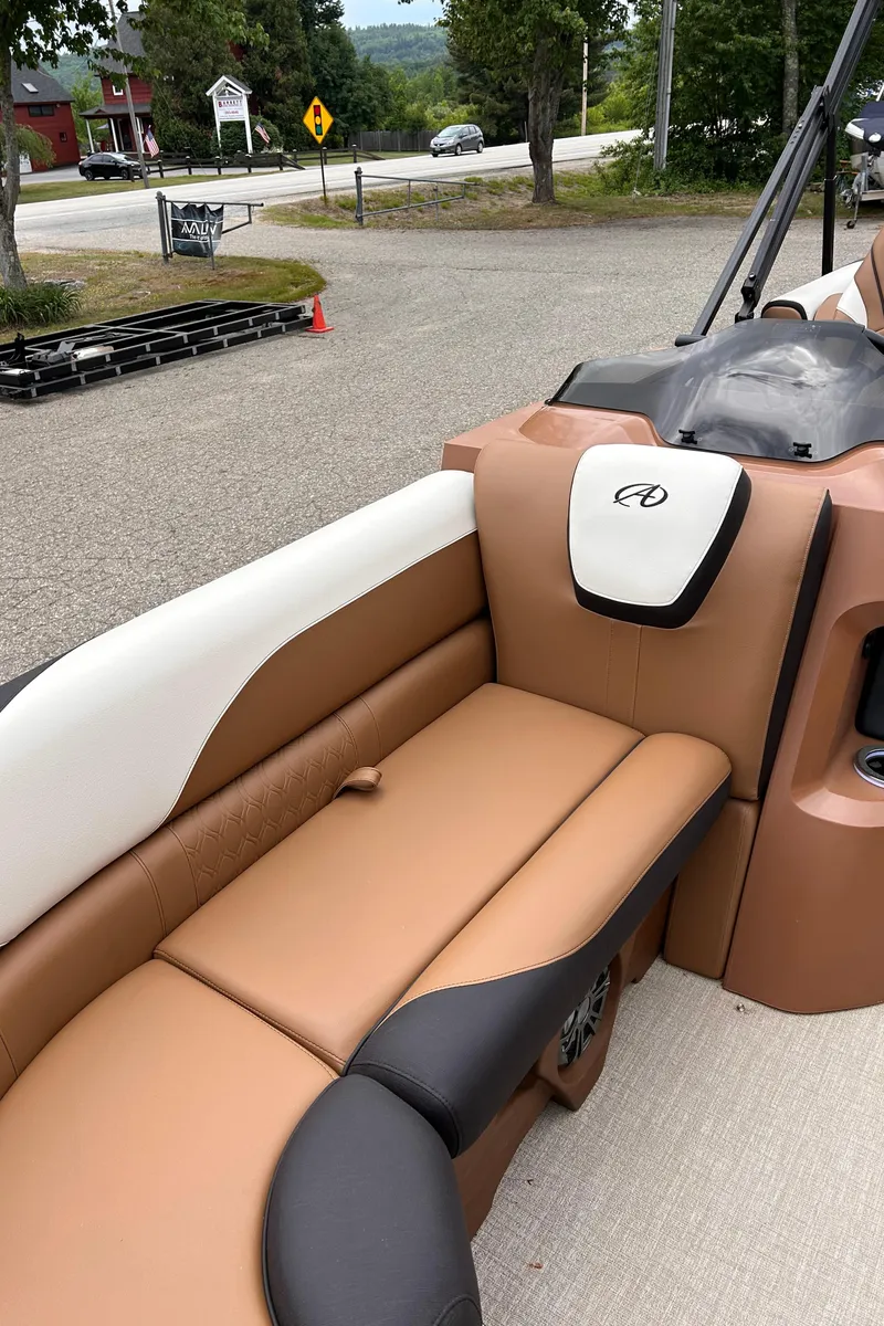 Slide: The Image of 2024 Avalon LSZ Entertainer 23' boat interior with tan and black seating. - 7