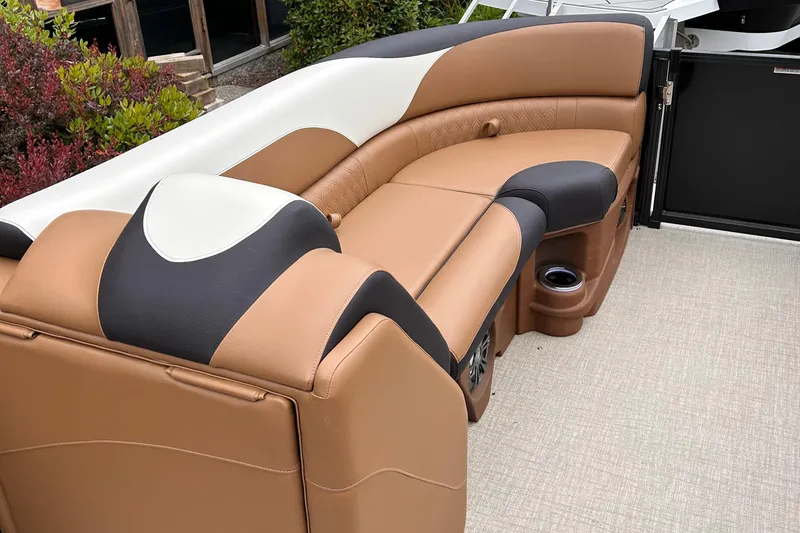 Slide: The Image of 2024 Avalon LSZ Entertainer 23' boat with luxurious tan and black seating. - 8