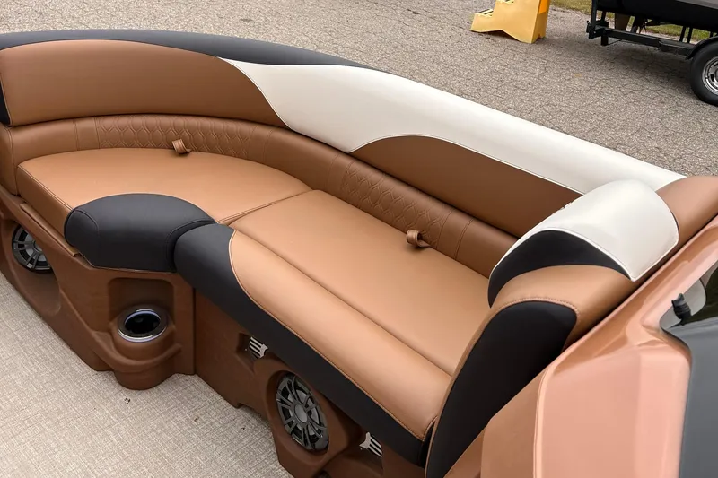 Slide: The Image of 2024 Avalon LSZ Entertainer 23' boat interior with tan and black seating. - 9