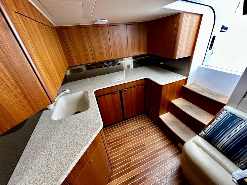 Slide: The Image of 2005 Viking 45 Open Express yacht kitchen with wooden cabinets and countertops - 38