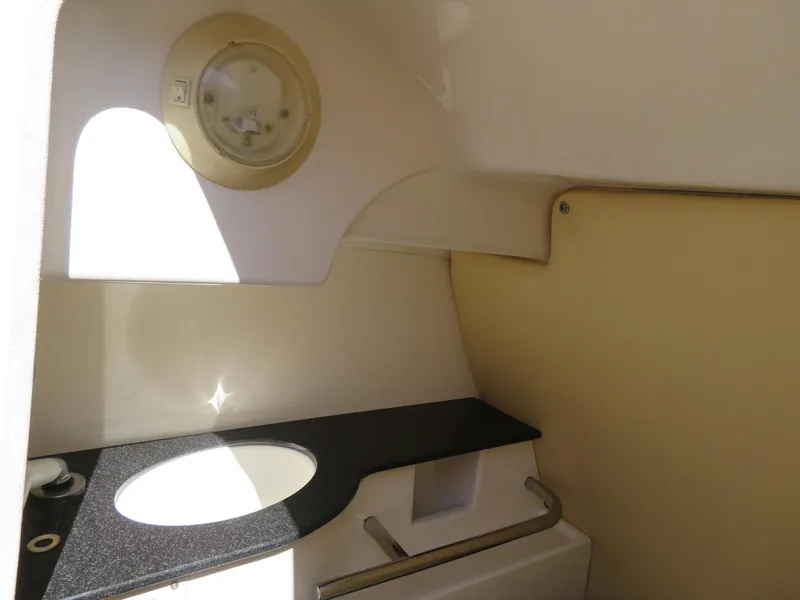 Slide: The Image of 2009 MasterCraft MariStar 255 boat interior bathroom with sink and countertop. - 11
