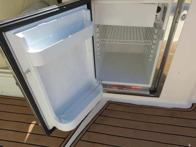 Slide: The Image of Open refrigerator on 2009 MasterCraft MariStar 255 boat with teak flooring. - 13