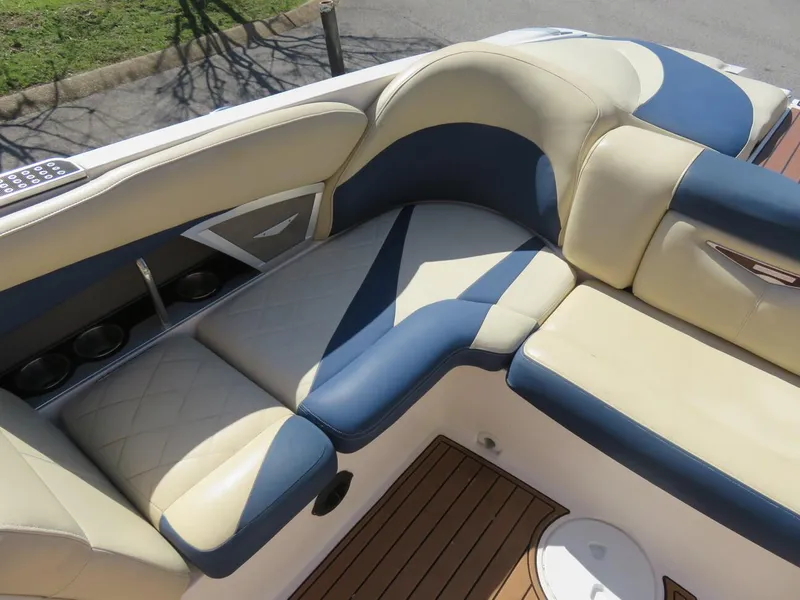 Slide: The Image of 2009 MasterCraft MariStar 255 boat interior with beige and blue cushioned seating. - 14