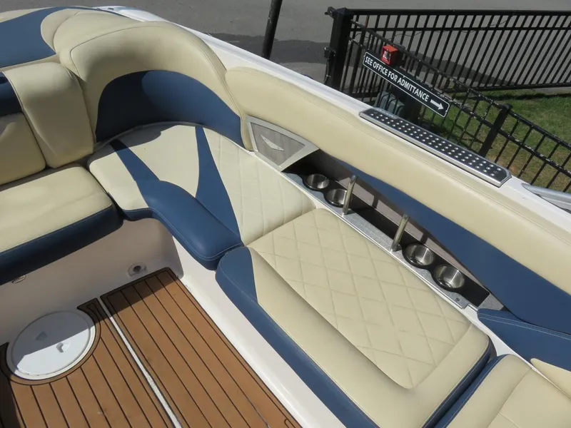 Slide: The Image of 2009 MasterCraft MariStar 255 boat interior with beige and blue seating. - 15