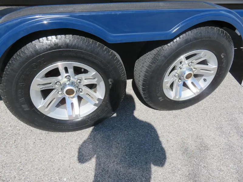 Slide: The Image of 2009 MasterCraft MariStar 255 trailer wheels on asphalt. - 21