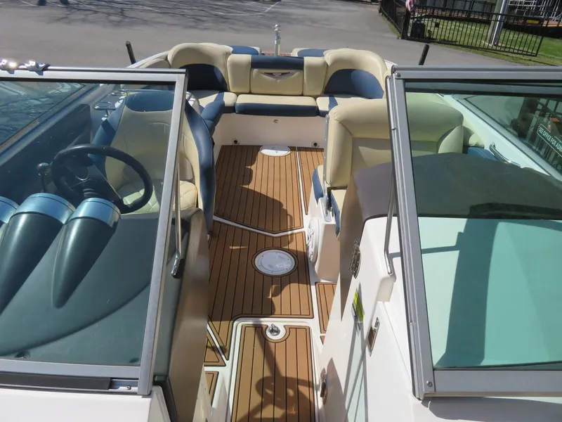 Slide: The Image of 2009 MasterCraft MariStar 255 boat interior with teak flooring and beige seating. - 6