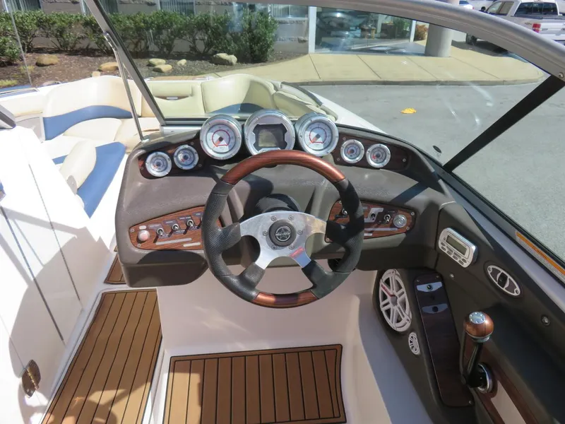 Slide: The Image of 2009 MasterCraft MariStar 255 boat dashboard with steering wheel and control panel. - 7