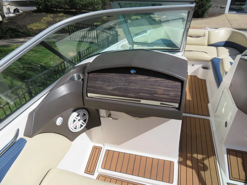 Slide: The Image of 2009 MasterCraft MariStar 255 boat interior with wood accents and seating. - 8
