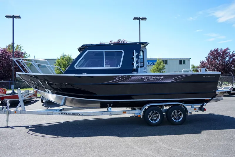 Slide: The Image of 2025 Weldcraft 240 Ocean King boat on a trailer in a parking lot. - 10