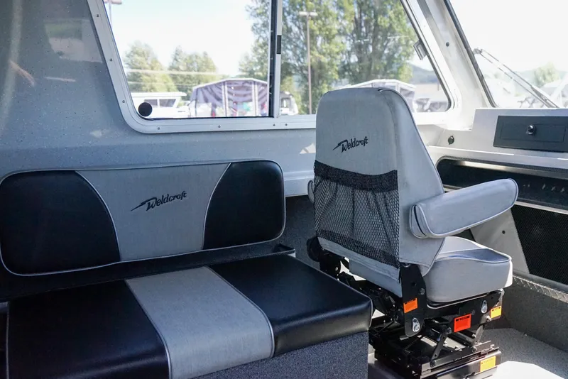 Slide: The Image of Interior of 2025 Weldcraft 240 Ocean King boat with grey and black seating. - 13