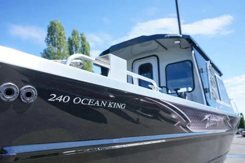 Slide: The Image of 2025 Weldcraft 240 Ocean King boat exterior close-up under blue sky. - 15