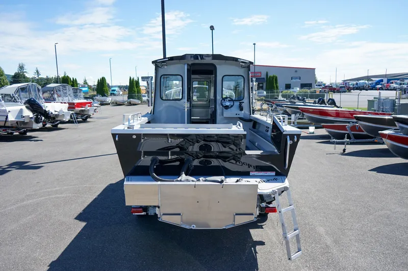Slide: The Image of 2025 Weldcraft 240 Ocean King boat displayed in a marina, rear view. - 6