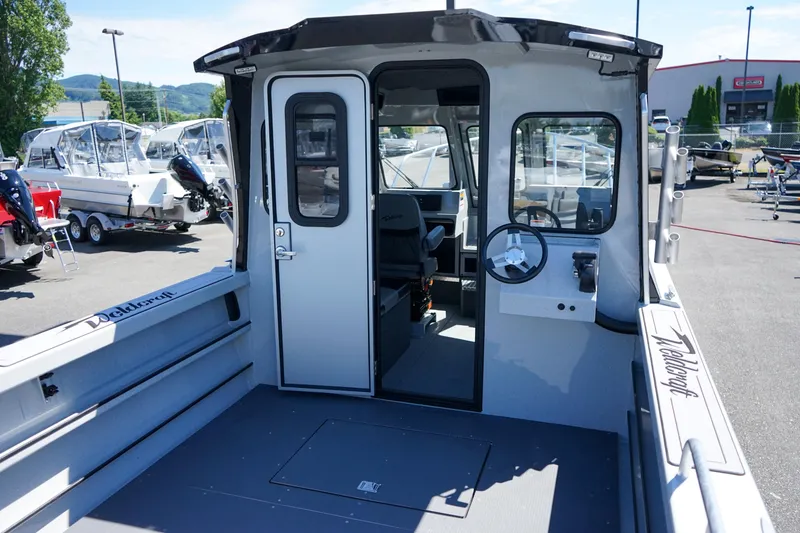 Slide: The Image of 2025 Weldcraft 240 Ocean King boat interior with steering wheel and seating. - 7