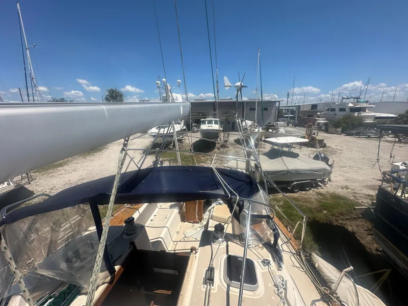 Slide: The Image of Island Packet 420 sailboat, 2002 model, docked in a marina under a clear blue sky. - 10
