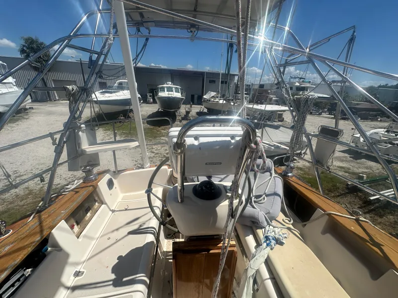 Slide: The Image of Island Packet 420 sailboat cockpit, 2002 model, in a boatyard with other vessels. - 13