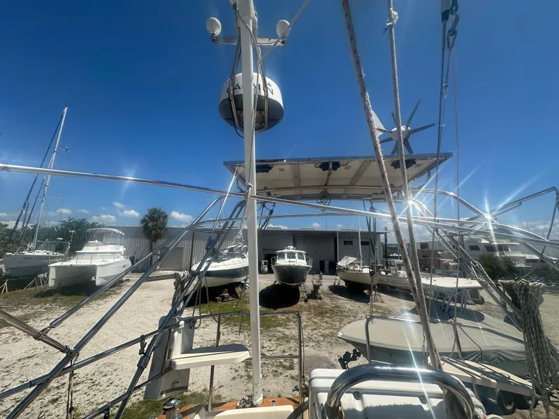 Slide: The Image of Island Packet 420 sailboat, 2002 model, docked among other boats under a clear blue sky. - 14