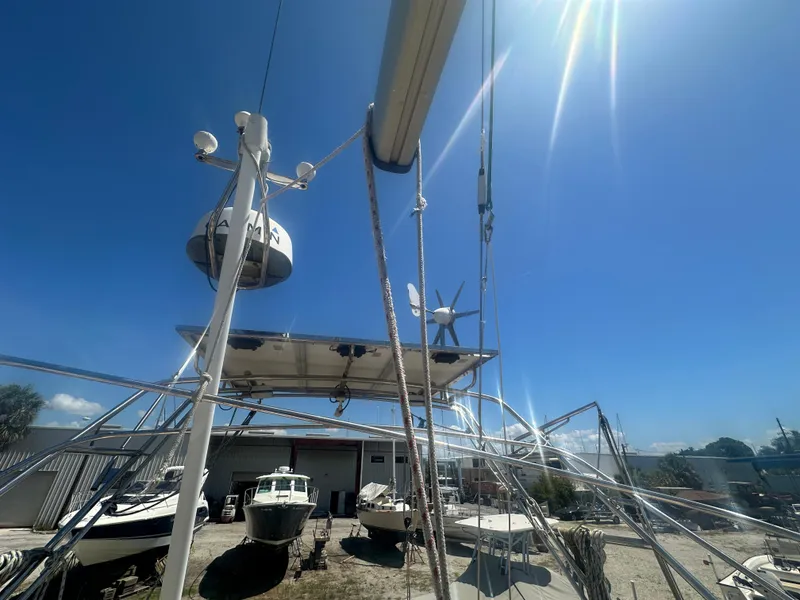 Slide: The Image of Island Packet 420 sailboat, 2002 model, docked in a sunny boatyard with clear blue skies. - 15