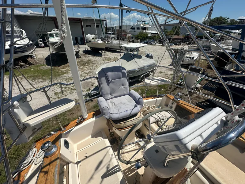 Slide: The Image of Cockpit of a 2002 Island Packet 420 sailboat with cushioned seating. - 17