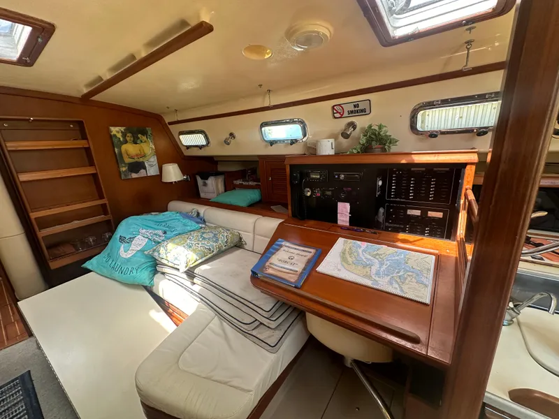Slide: The Image of Interior of 2002 Island Packet 420 sailboat with navigation station and cozy seating area. - 18