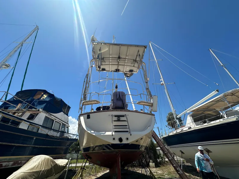 Slide: The Image of Island Packet 420 sailboat, 2002 model, docked on land under a clear blue sky. - 2
