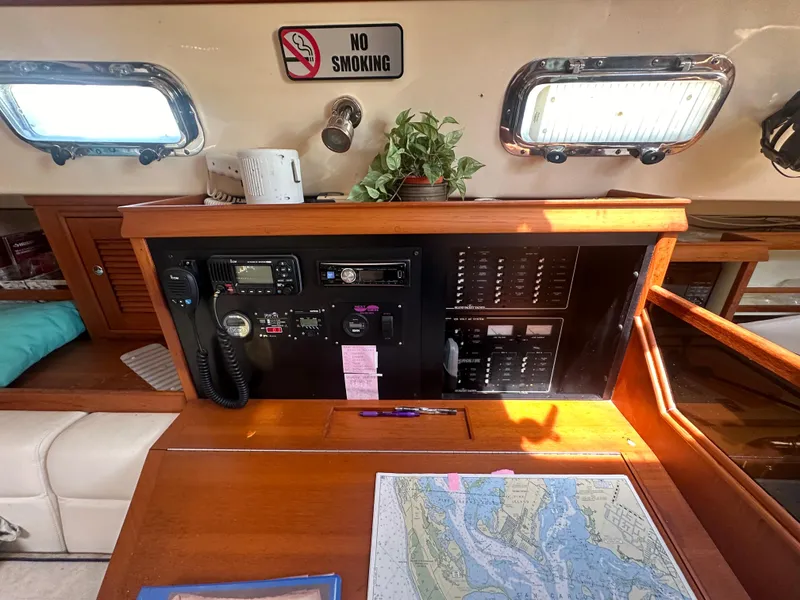 Slide: The Image of Navigation station of a 2002 Island Packet 420 sailboat with chart, radio, and No Smoking sign. - 20