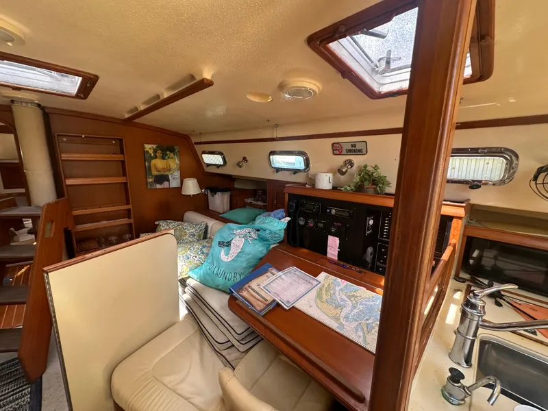 Slide: The Image of Interior of 2002 Island Packet 420 sailboat with cozy seating and navigation station. - 39