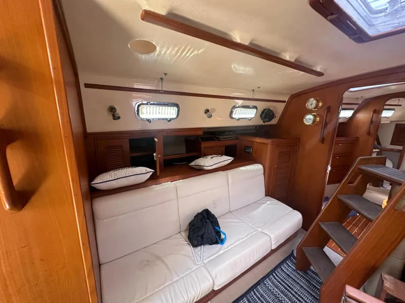 Slide: The Image of Interior of 2002 Island Packet 420 sailboat with white sofa and wooden cabinetry. - 40